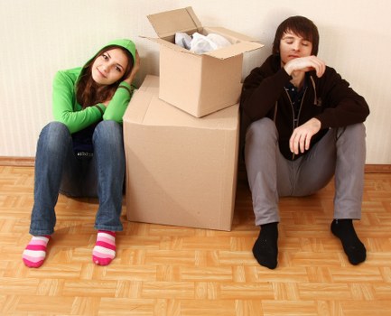 Professional movers handling boxes and furniture in a Merton flat relocation