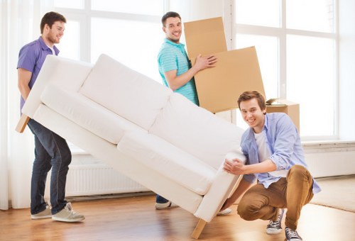 Packed moving boxes and furniture ready for transport in a Merton home move
