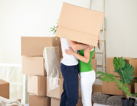 Local movers organising labelled boxes during a move in Merton