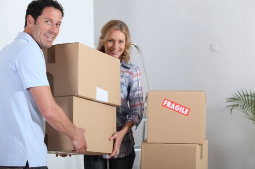 Careful unpacking of household boxes in a Merton property